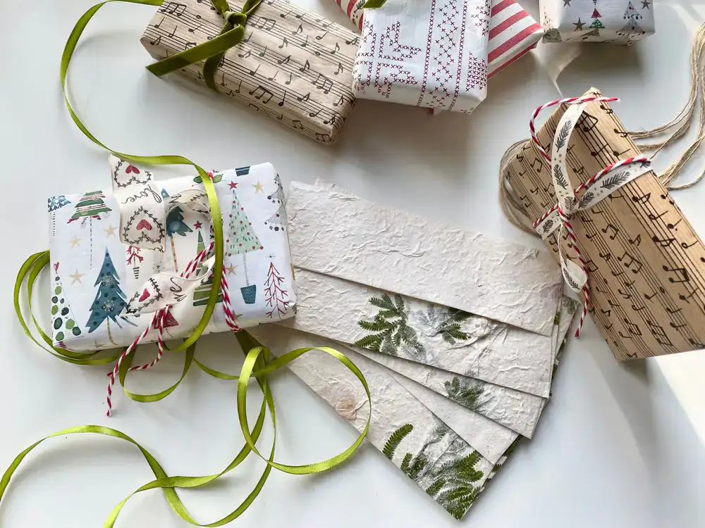 Flat lay of artisan paper, ribbons, and beautifully wrapped gifts from above