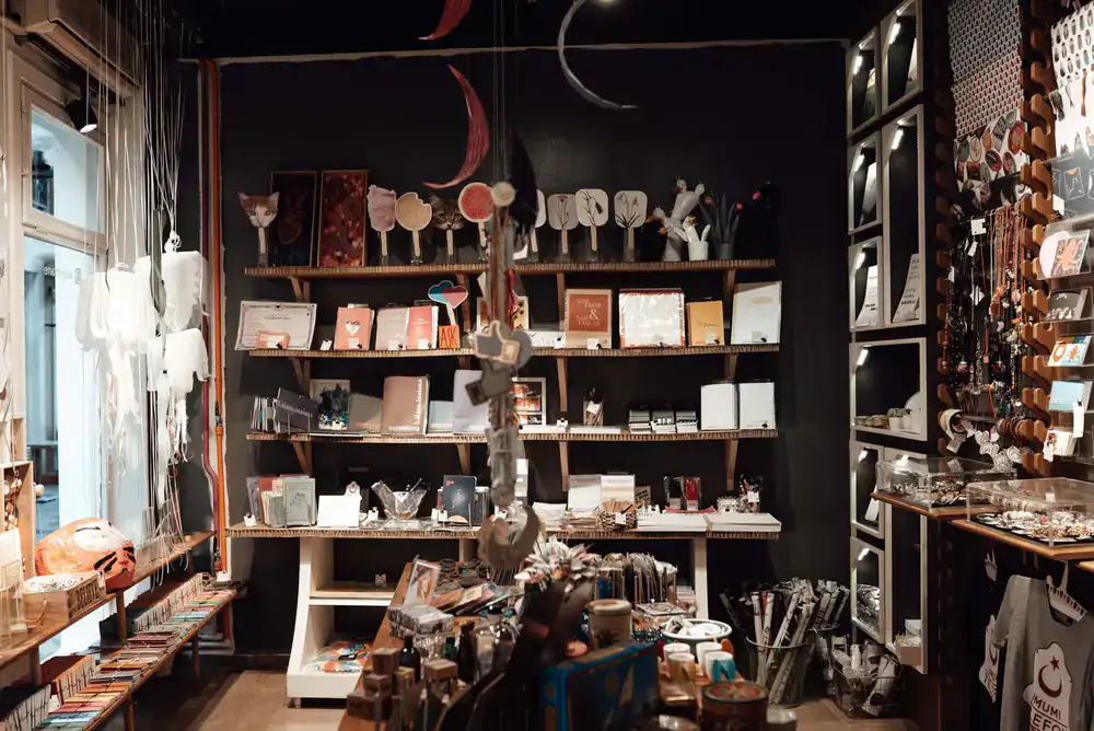 Interior of a charming stationery boutique with wooden shelves displaying paper rolls