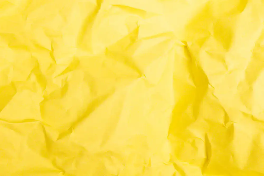 Close up of hands carefully creasing decorative paper