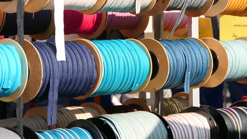 Wooden spools wrapped in colorful velvet and silk ribbons